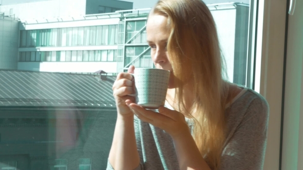 Woman Drinking Morning Tea By Window