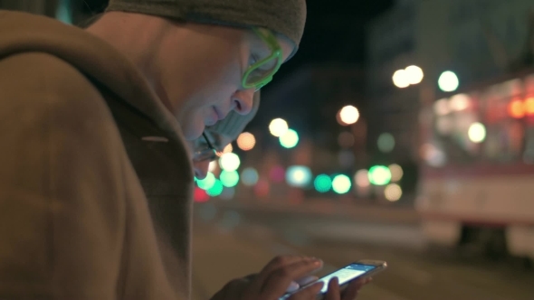 Woman Typing In Smartphone On The Bus Stop