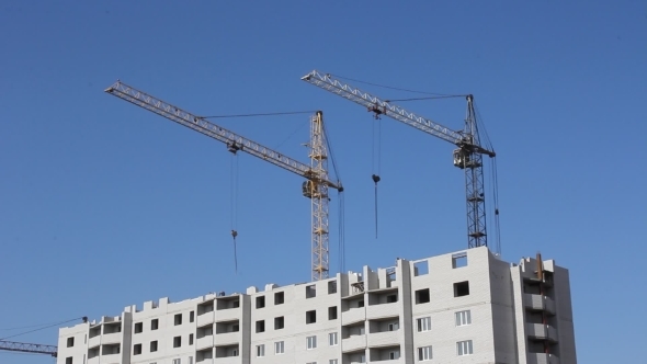 Tower Cranes Against Blue Sky, With Clouds