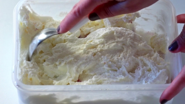 Woman Pulls Out Vanilla Homemade Ice Cream