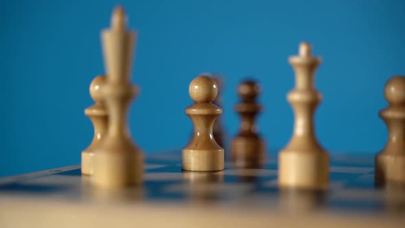 White and Black Wooden Pieces on a Chessboard