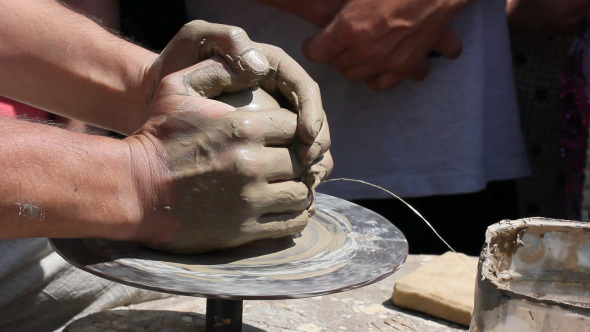 Potter's Hands Working Clay On Potter's Wheel