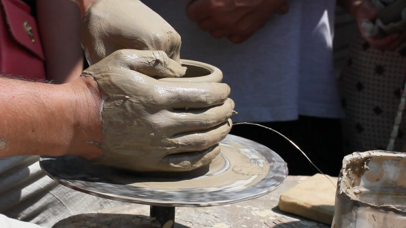 Potter's Hands Working Clay On Potter's Wheel