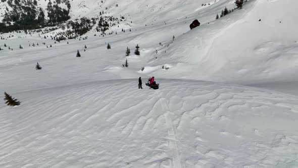 Snowmobile high in the mountains aerial view 4 K