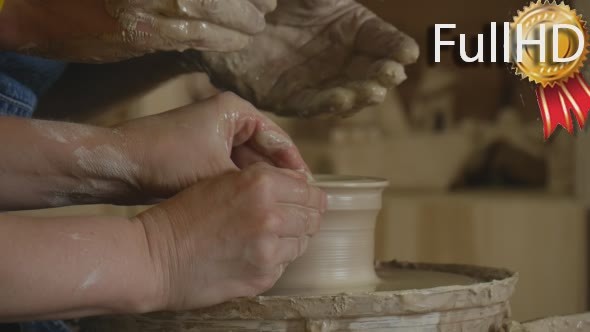 Two Potters Craftsmen are Working on Pottery