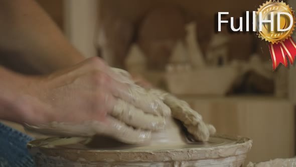Potter Craftsman is Working on Pottery Wheel