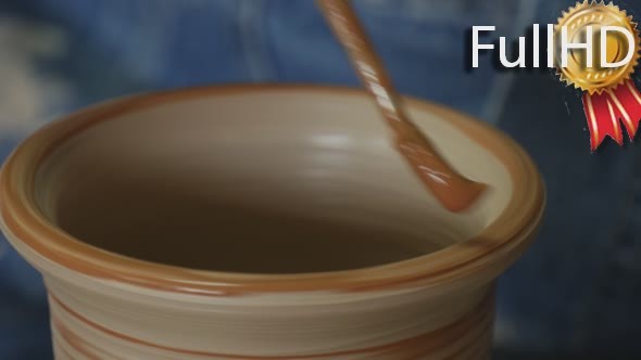 Potter Craftsman in Jeans is Working on Pottery