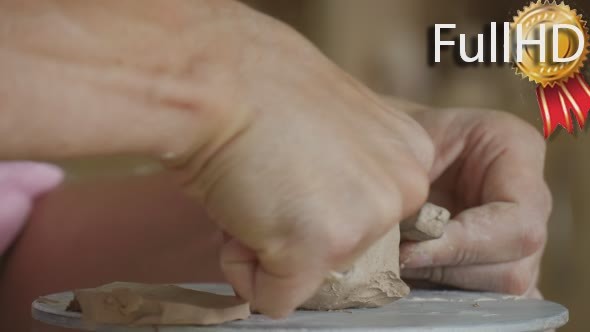 Male of Female Potter Craftsman is Making a Clay