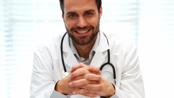 Portrait of male doctor sitting at desk