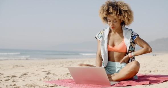 Woman With Laptop On The Summer Beach