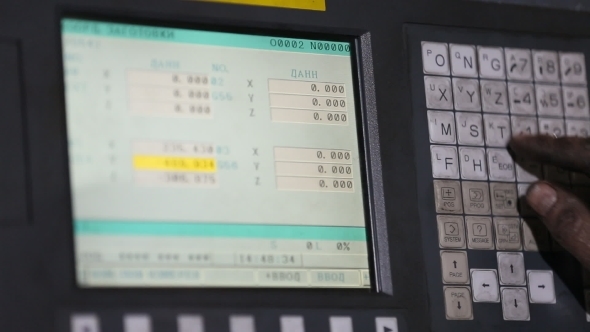 Operator Presses On The Keyboard Of The Machine