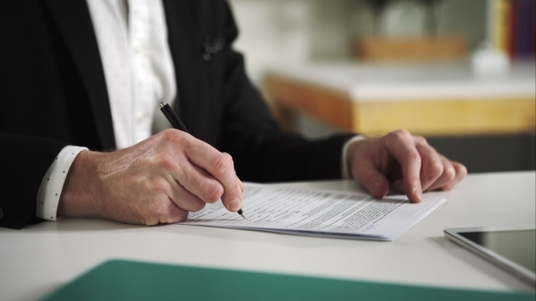 Businessman Signs Documents