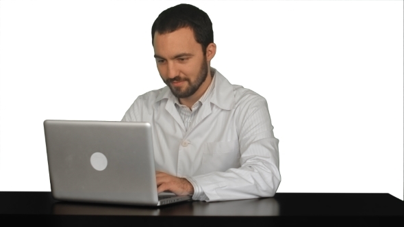 Concentrated Male Doctor Using Laptop At Medical