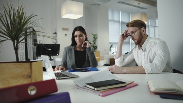 Employees Discussing Work In The Office