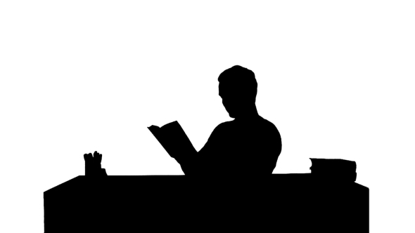 Silhouette Portrait Of a Male Student Reading a