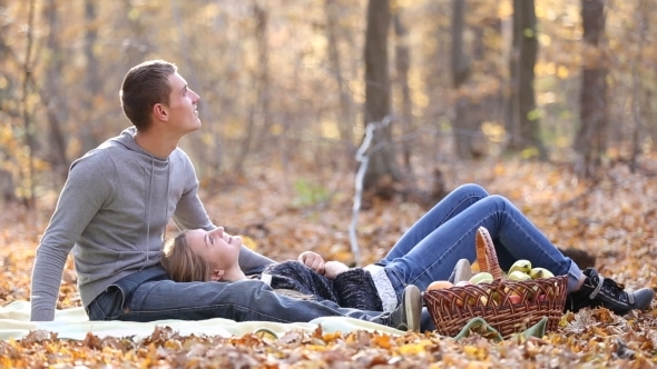 Couple Sitting In The Woods