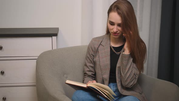 Angry Woman Writing Notes and Talking on Mobile Phone at Home