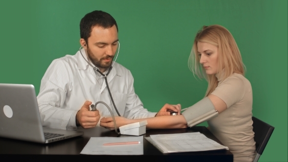 Doctor And Patient With Blood Pressure Meter In a