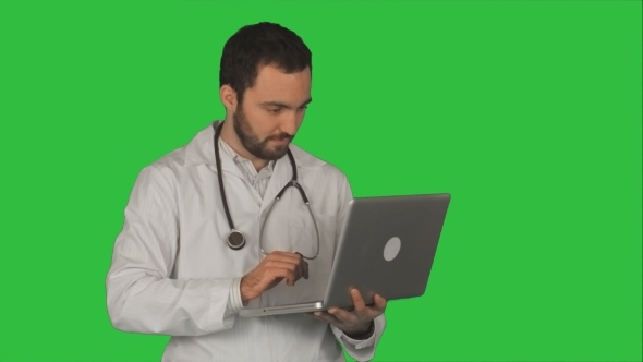 Medical Doctor Working With Laptop On a Green