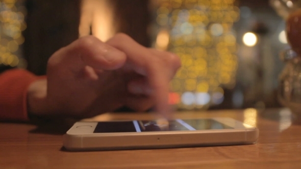 Man Texting On a Smatphone In Cafe 