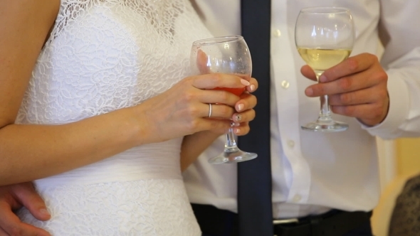 The Bride And Groom Holding Glasses