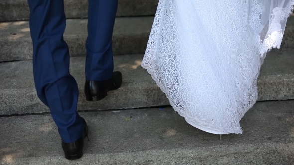 The Bride And Groom Go Up The Stairs