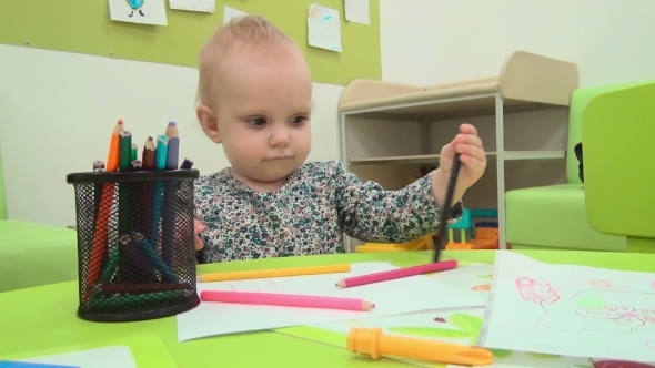 Little Baby Plays With Pencils