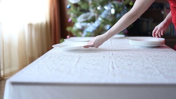 Young Woman Serves a Festive Table