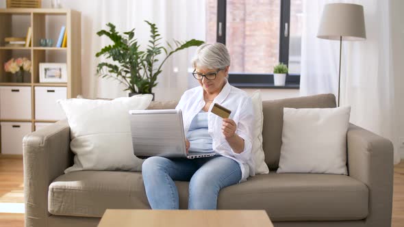 Senior Woman with Laptop and Credit Card at Home 