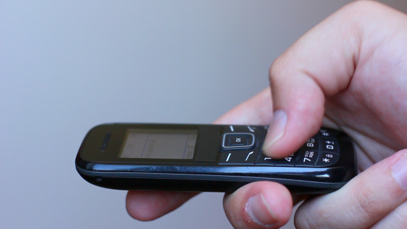Hand Typing Text Message On The Cell Phone