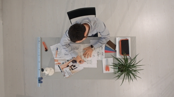 Top View Of Young Architect Working At Office Desk