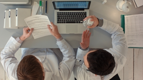 Scientists Looking Attentively At Pill In Hospital