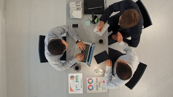 Top View Of Business Partners Discussing Documents alt