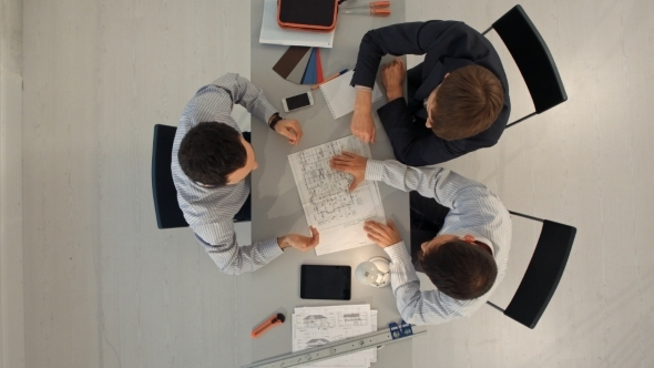 Architects In Office Looking At Construction alt