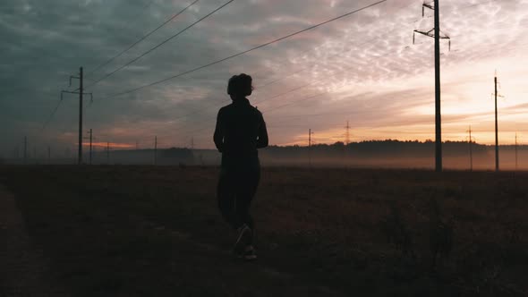 Sporty Female Jogger Is Running and Training Outside at the Nature. Athletic Woman Is Running During