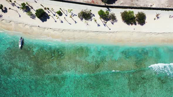 Beautiful aerial clean view of a white paradise beach and blue sea background in colourful 4K