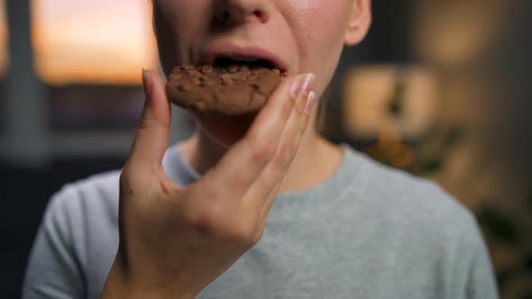 Woman Eats a Chocolate Chip Cookies