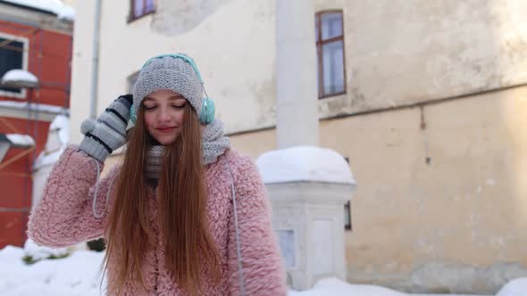 Girl Tourist During Her Vacation Listening to Music Via Headphones and Dancing in Old City Center