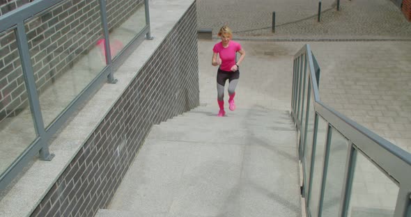 Young Woman Jogging Up the Stairs