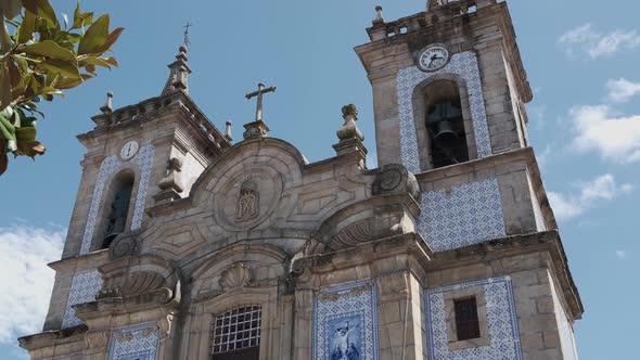 Facade covered with azulejos tiles of Sao Pedro church in Gouveia, Portugal. Tilt down