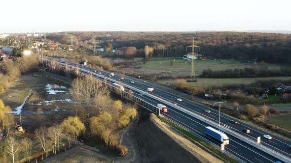 Aerial Shot of Highway with Cars During Sunny Day - Village and Nature in Surroundings