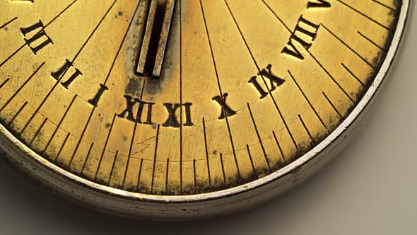 Dial of a Sundial Spinning on a White Background. Close Up