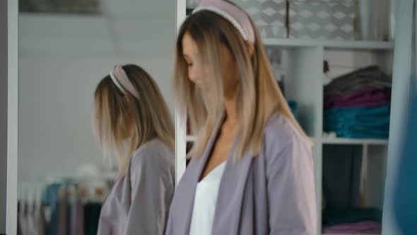 Trendy Woman Spinning Near Mirror in Shop
