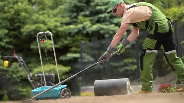 Professional Gardener Preparing Soil in Backyard Garden