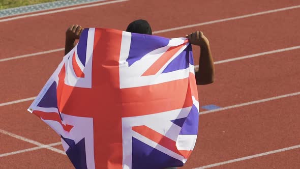 Excited Champion Showing Flag of Great Britain to Supporters, Pride of Nation