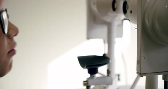 Optometrist Checks Kid's Vision Using Opthalmology Medical Device