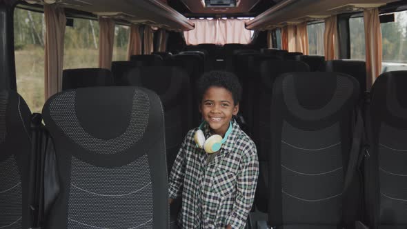 Portrait of Happy Boy in Empty Bus