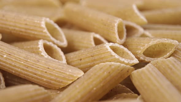 Uncooked penne pasta macro shot