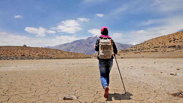 Woman Traveler Walks On A Dry Mountain Lake