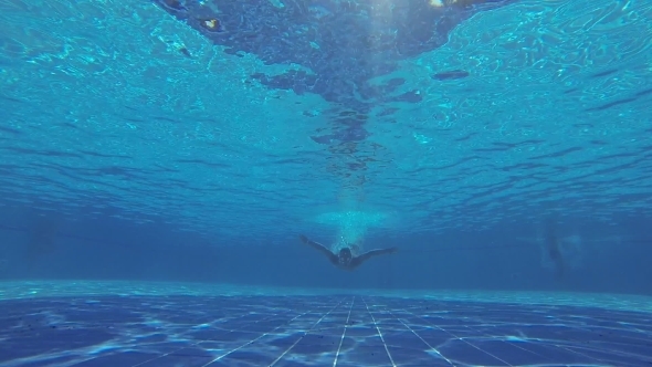 Underwater Swimming. Man Swims In The Pool